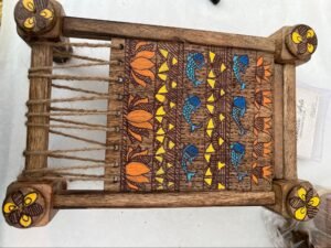 Madhubani patterns at small wooden cot
